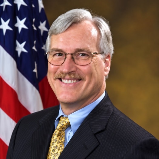 Jeffrey L. Sedwick photographed in front of the U.S. flag