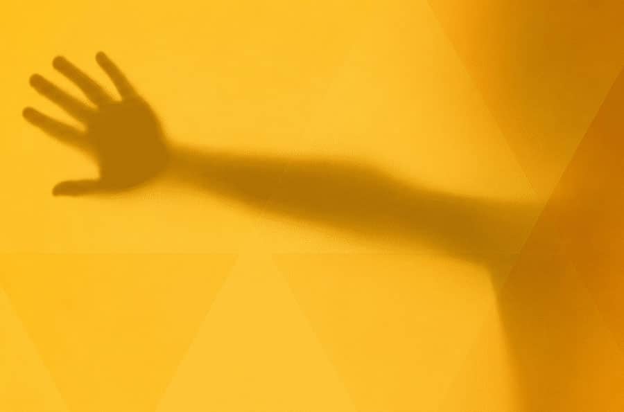 Shadow of a child's hand behind opaque glass
