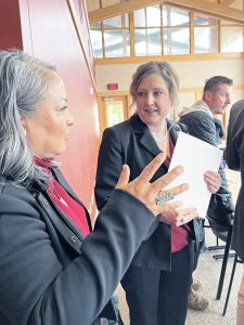AIIC Program Manager Tyesha Wood, left, talks with AATTAP Administrator Janell Rasmussen at the start of the event.