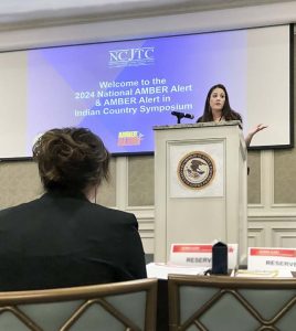 Sibling-survivor Kimber Biggs shares her story during the Symposium. {Photo credit: AATTAP}