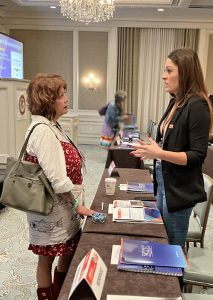 Sibling-survivor Kimber Biggs (right) talks with parent-survivor Pamela Foster at the Symposium. “Pamela is such an inspiration to me—and anyone who has endured a similar loss,” Biggs said. {Photo credit: AATTAP}