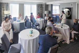 AATTAP Administrator Janell Rasmussen (standing) welcomes family survivors and others to a reception in honor of the forthcoming sibling-survivor resource, What About Me?