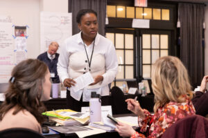 Three females at investigation desk in conference room