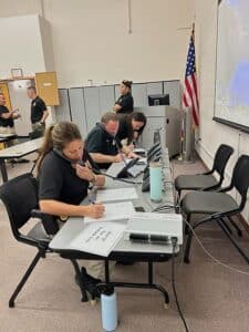 People taking calls at a long table