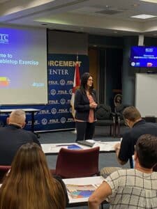 Woman with dark hear talking to seated audience