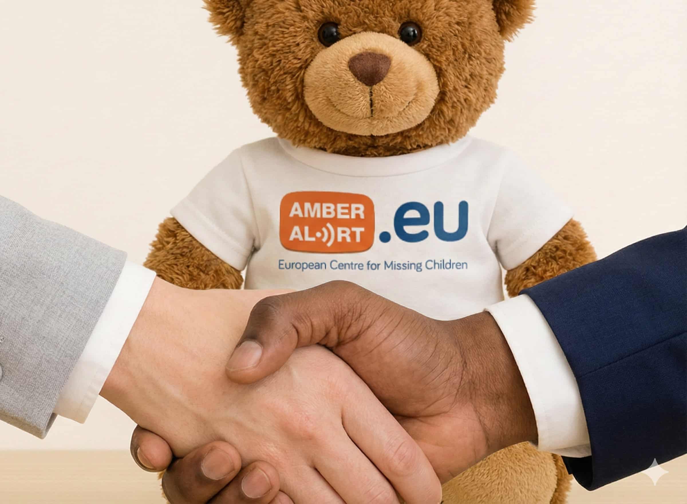 Photo of stuffed bear with T-shirt that reads AMBERAlert.eu. In front of the bear are two men's hands clasped in solidarity.