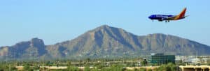 Southwest Airline jet landing at Arizona airport with mountains in the background