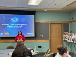 Woman standing in front of a screen in a classroom