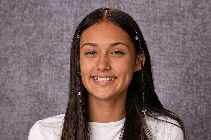 A young Native American girl smiling for school pictures