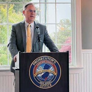 Male speaker at podium for Cape May Child Abduction Response Team USDOJ certification event.