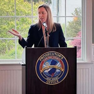 Female speaker at podium for Cape May Child Abduction Response Team USDOJ certification event.