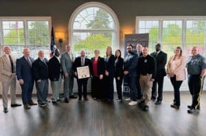 Group shot of Cape May Child Abduction Response Team receiving USDOJ certification plaque.