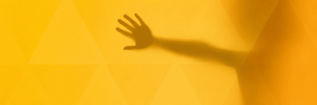 Shadow of a child's hand behind opaque glass
