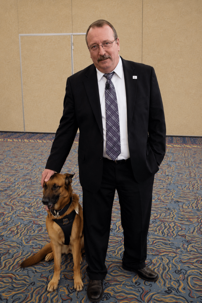 Photo of man (Jim Walters) with police dog