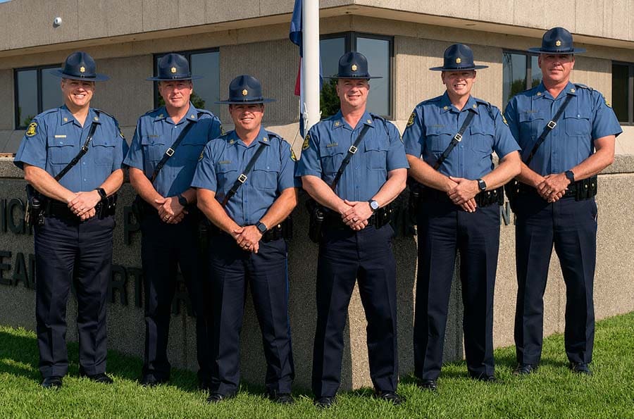 Lieutenant Chris Daniels, Lieutenant Jim Lowary, Lieutenant Morgan Patterson, Captain Jason Crites, Lieutenant Joe Davidson, Lieutenant Casey Utterback standing in fron of the corner of MSHP headquarters building