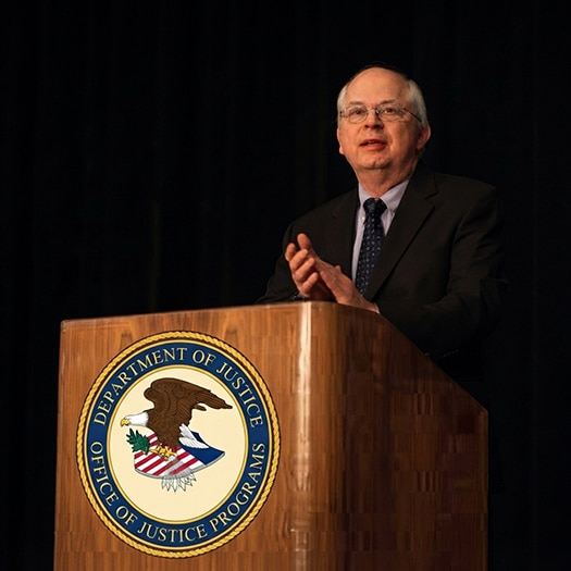 Assistant Secretary of Indian Affairs Larry Echo Hawk behind a podium