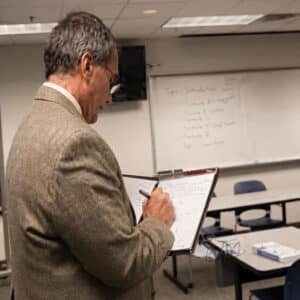 Gus Paidousis reviewing his notes for certification approval