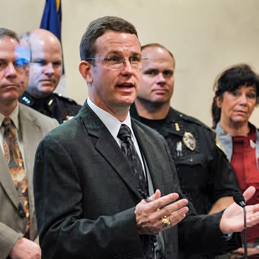 Charles Fleeger speaking at a press conference.