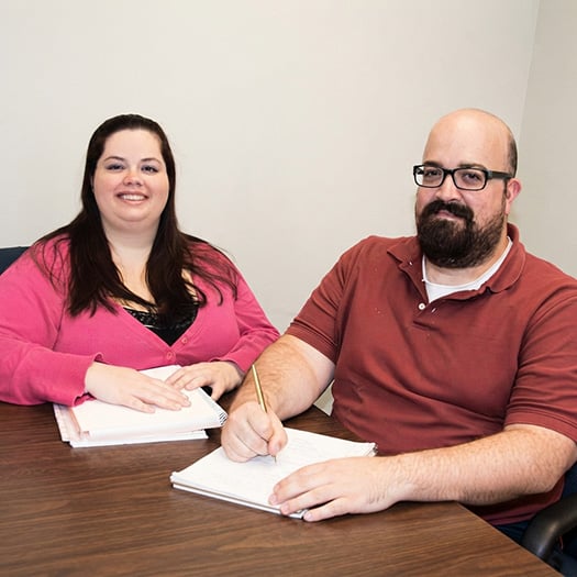 Two people seated at a table: Jessica Davenport, left, and Peter Warren