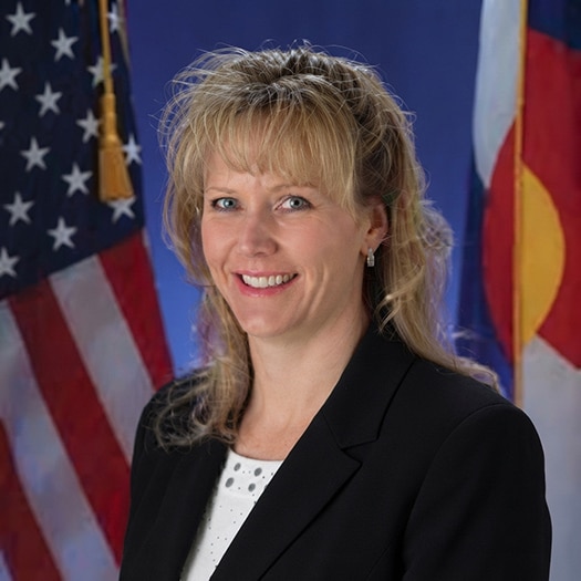 Kristina Bomba in front of a U.S. flag