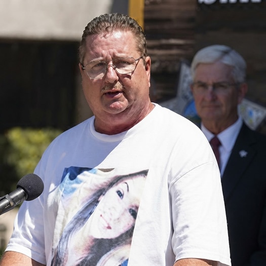 Brett Anderson speaking at a press conference related to his daughter, Hannah