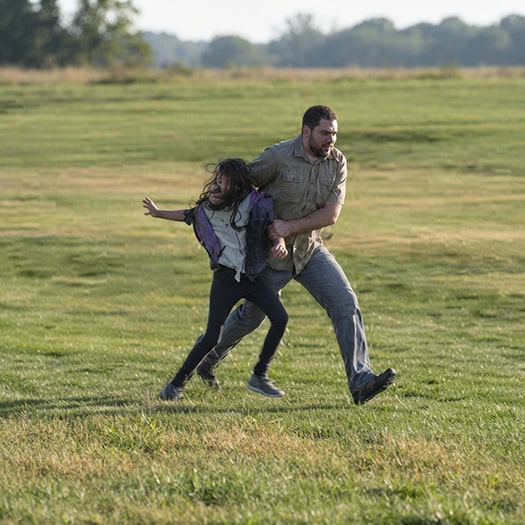 Man running with girl during mock abduction training
