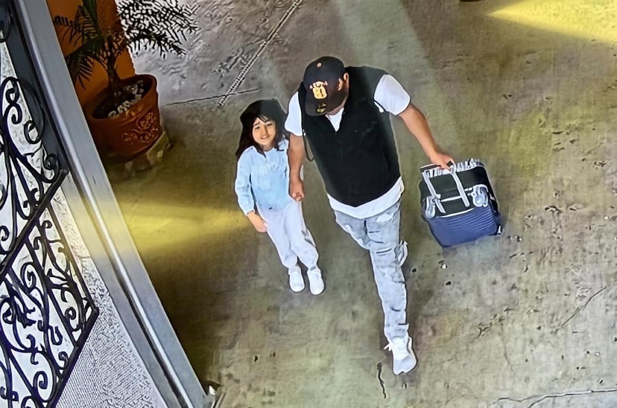 View from security camera of a Hispanic girl and her dad