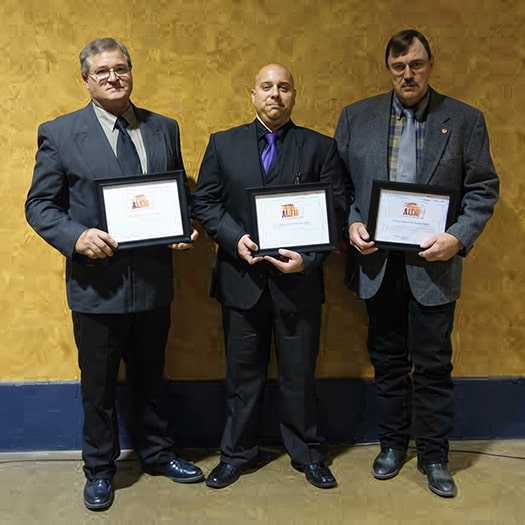 Three recipients of a law enforcement leadership award