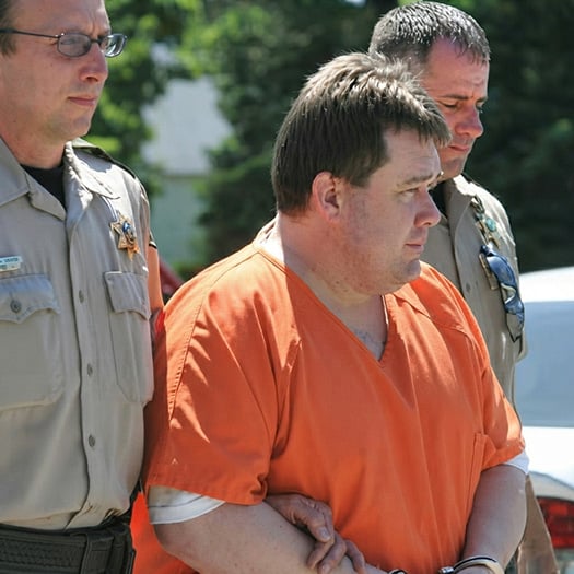 Suspect Thomas Petersen being escorted by law enforcement